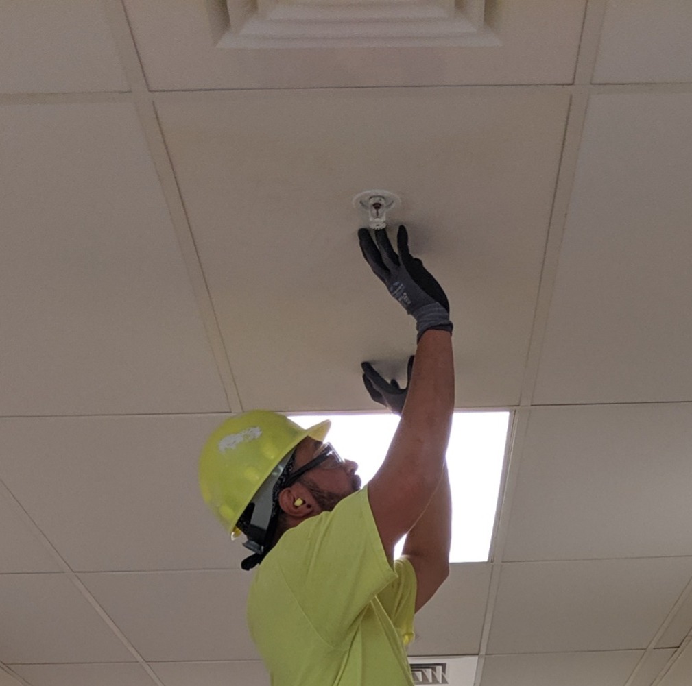 Commercial Drywall Dallas installing acoustic ceiling tiles and grid